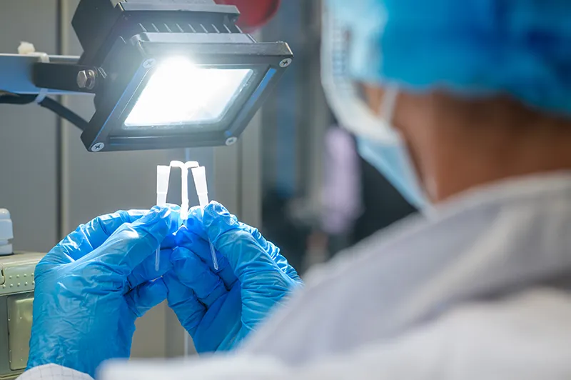 image of employee examining a component